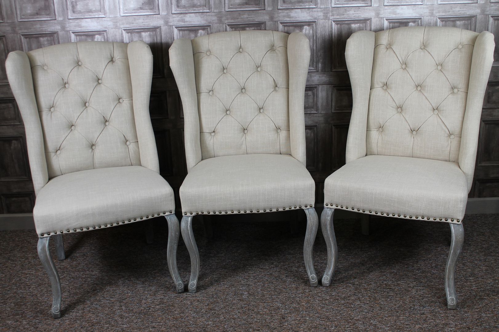 WINGED UPHOLSTERED FRENCH STYLE DINING CHAIRS WITH BUTTON BACK IN STONE